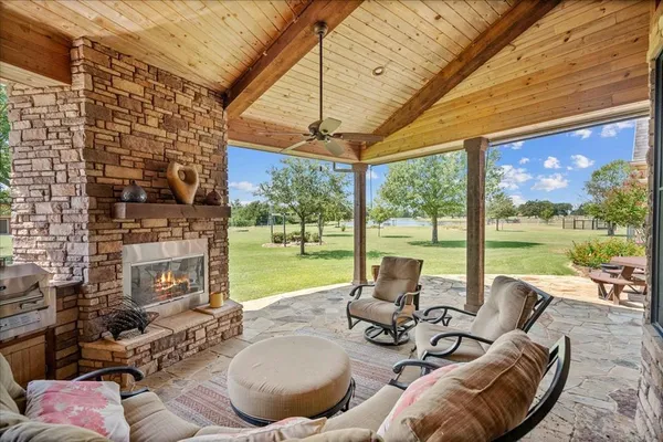 a living room with patio furniture and garden view