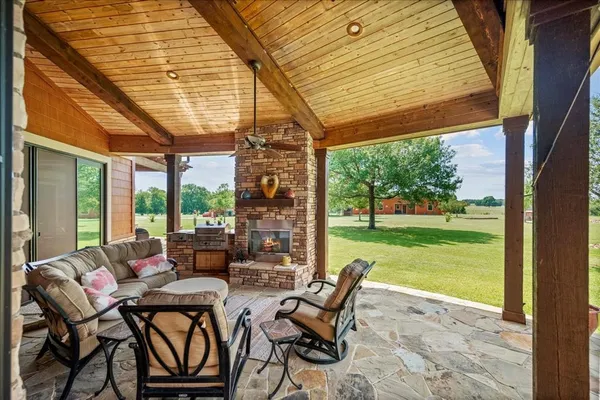 a living room with patio furniture and garden