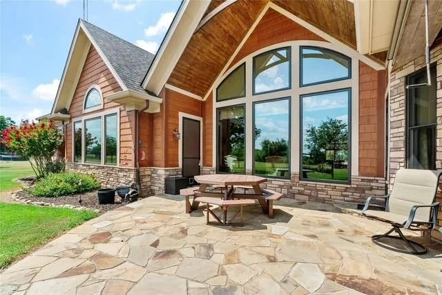 a view of house with yard and sitting area