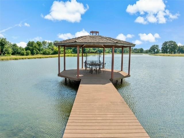 695 County Rd Road Honey Grove, TX 75446 - Photo 36 of 40 a view of a patio with a table chairs and a table