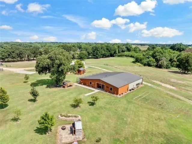 an aerial view of a house with yard swimming pool and outdoor seating