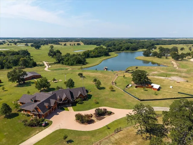 an aerial view of a residential houses with outdoor space