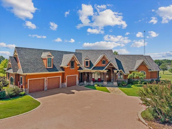 a front view of house with yard outdoor seating and green space