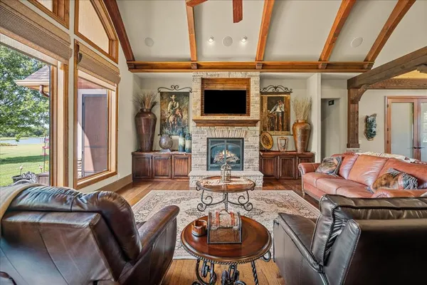 a living room with fireplace furniture and a flat screen tv