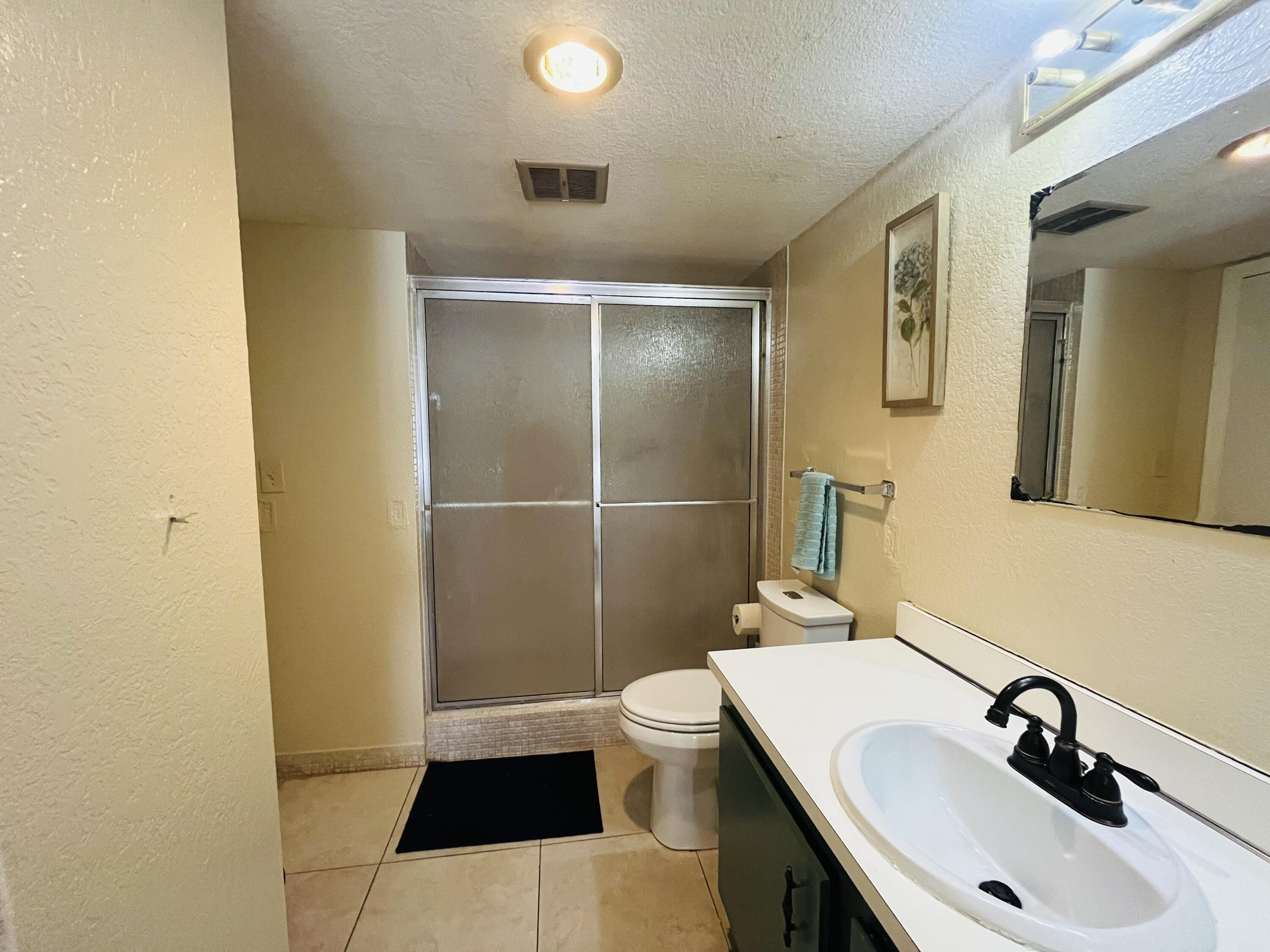 4160 Inverrary Drive, Unit 207 Lauderhill, FL 33319 - Photo 11 of 13 a bathroom with a sink a toilet and shower