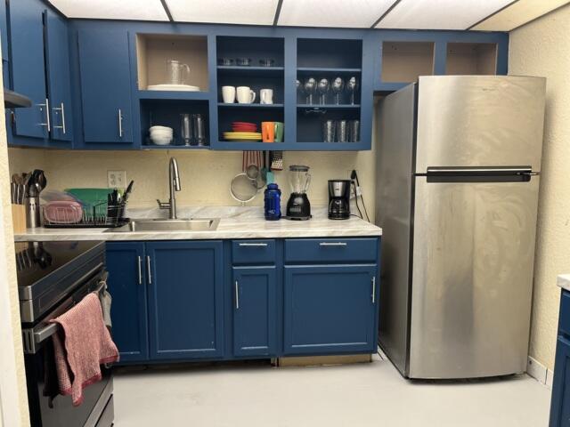 4160 Inverrary Drive, Unit 207 Lauderhill, FL 33319 - Photo 3 of 13 a kitchen with refrigerator and cabinets