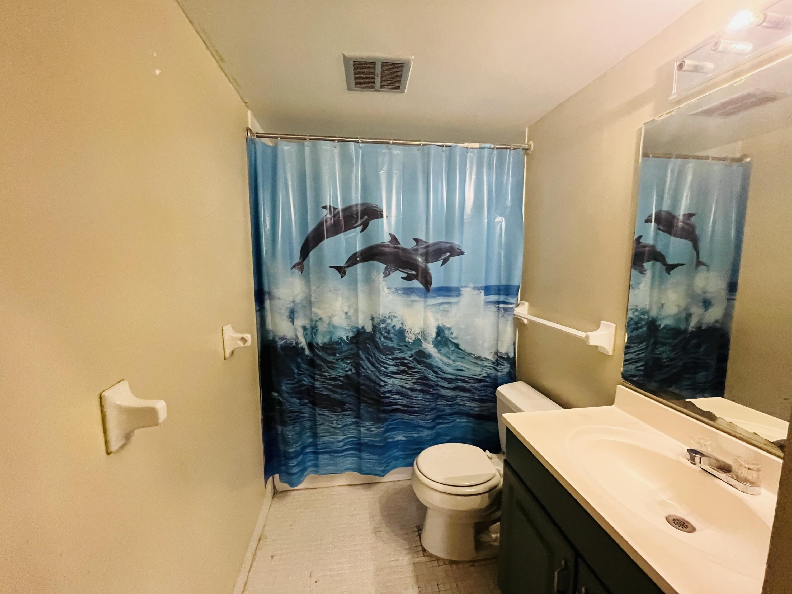 4160 Inverrary Drive, Unit 207 Lauderhill, FL 33319 - Photo 8 of 13 a bathroom with a sink a toilet and shower