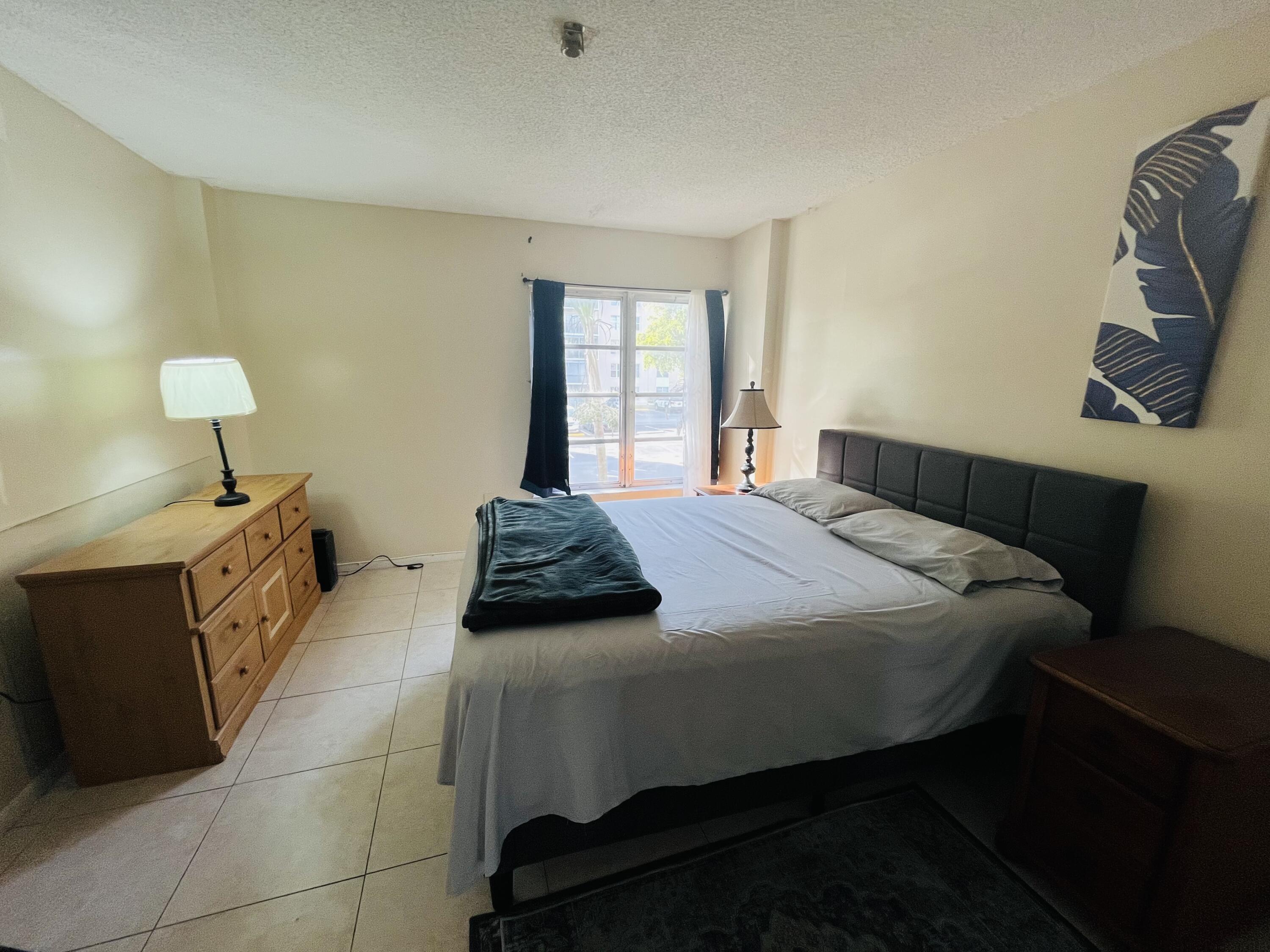 4160 Inverrary Drive, Unit 207 Lauderhill, FL 33319 - Photo 9 of 13 a bedroom with a bed and window