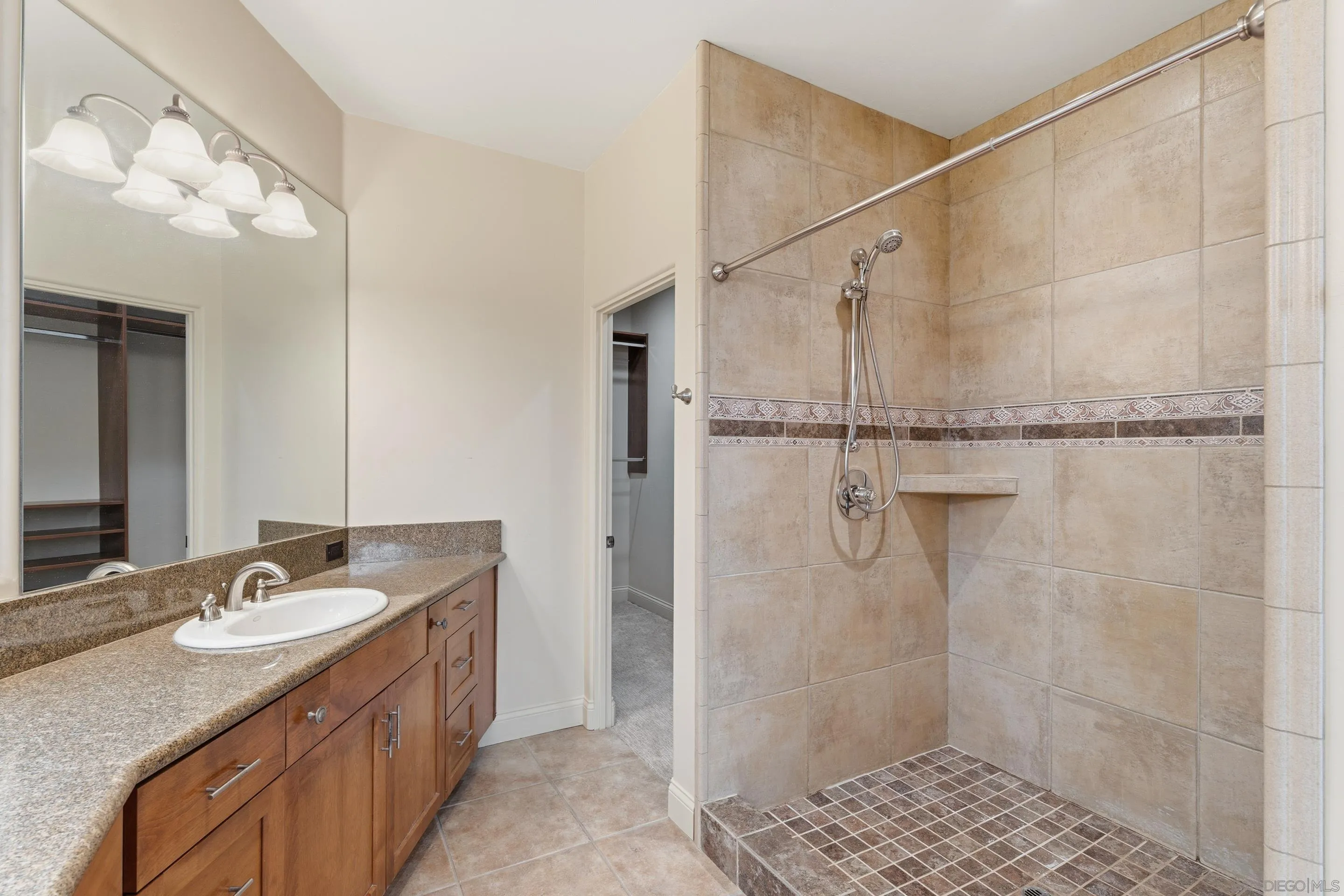 11020 Explorer Road El Cajon, CA 92020 - Photo 16 of 29 a bathroom with a granite countertop shower sink vanity and mirror