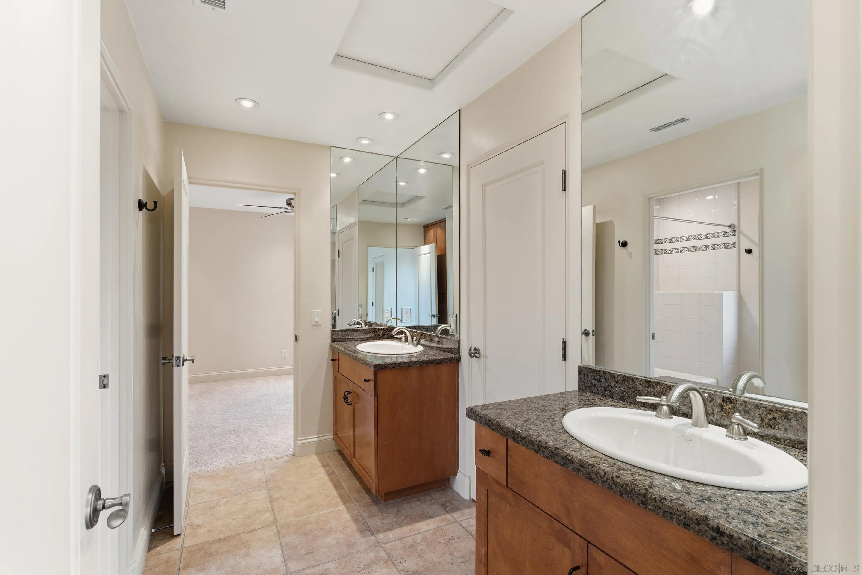 11020 Explorer Road El Cajon, CA 92020 - Photo 21 of 29 a bathroom with a granite countertop sink shower and a mirror