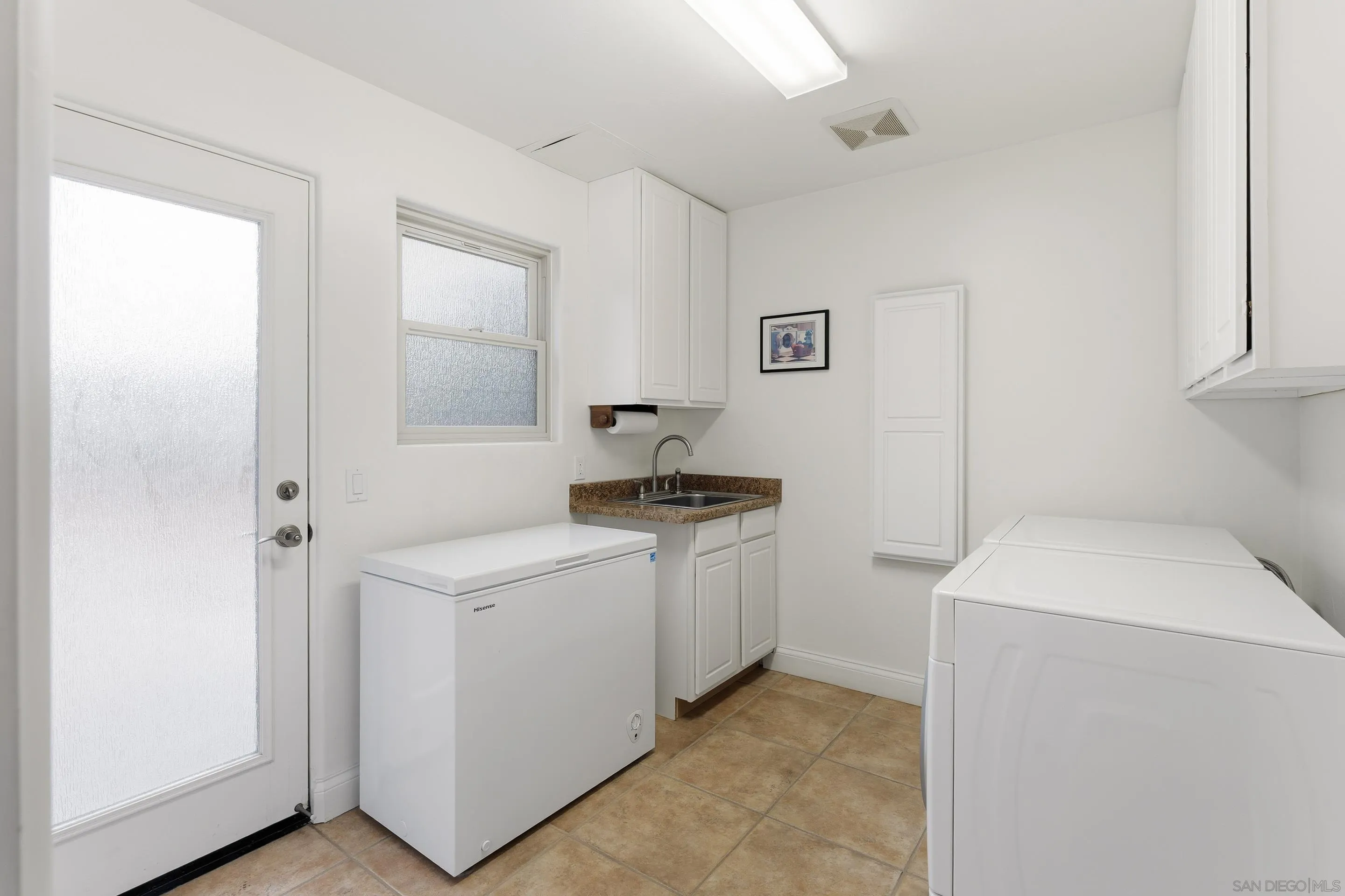 11020 Explorer Road El Cajon, CA 92020 - Photo 22 of 29 a utility room with cabinets washer and dryer