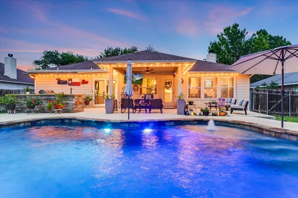 an outdoor space with pool and furniture