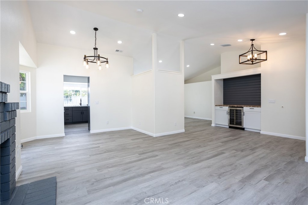 45800 Classic Way Temecula, CA 92592 - Photo 12 of 61 wooden floor in an empty room with a kitchen