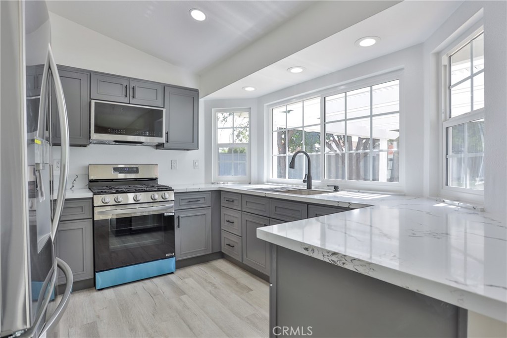 45800 Classic Way Temecula, CA 92592 - Photo 18 of 61 a kitchen with granite countertop a stove a sink and a refrigerator