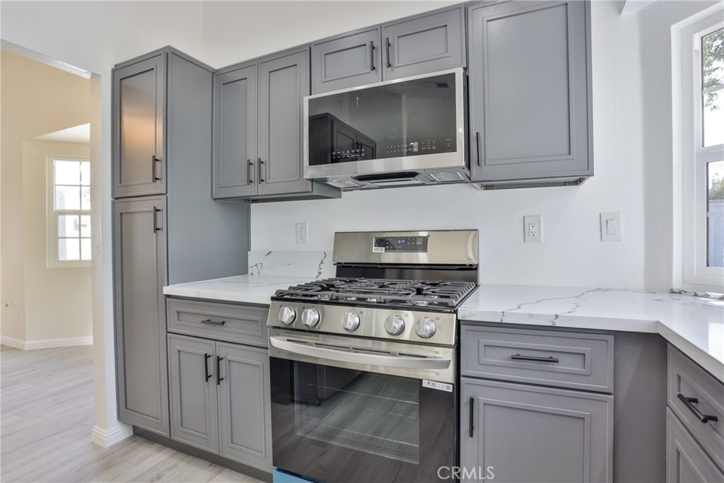 45800 Classic Way Temecula, CA 92592 - Photo 19 of 61 a kitchen with stainless steel appliances granite countertop a stove and a microwave