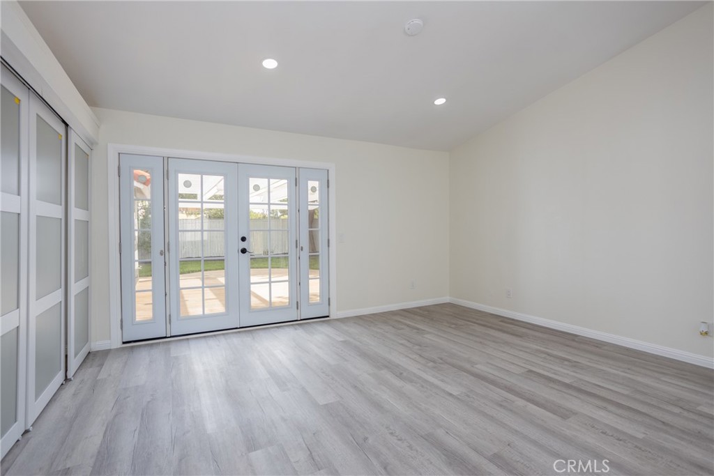 45800 Classic Way Temecula, CA 92592 - Photo 22 of 61 a view of an empty room with wooden floor and a window