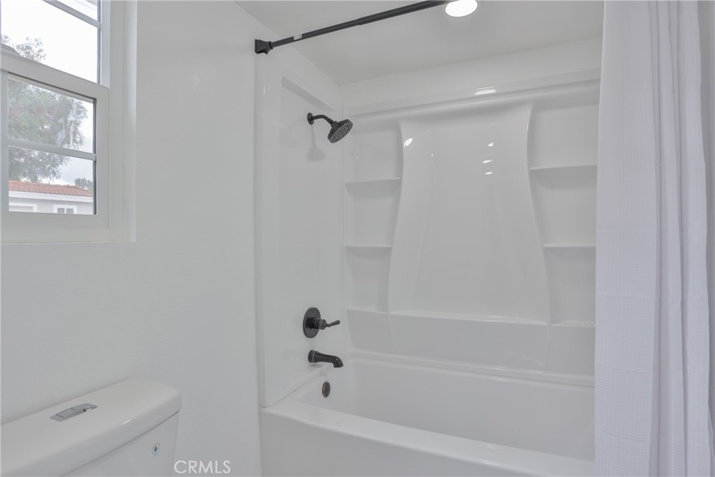 45800 Classic Way Temecula, CA 92592 - Photo 28 of 61 a bathroom with a bathtub and a toilet