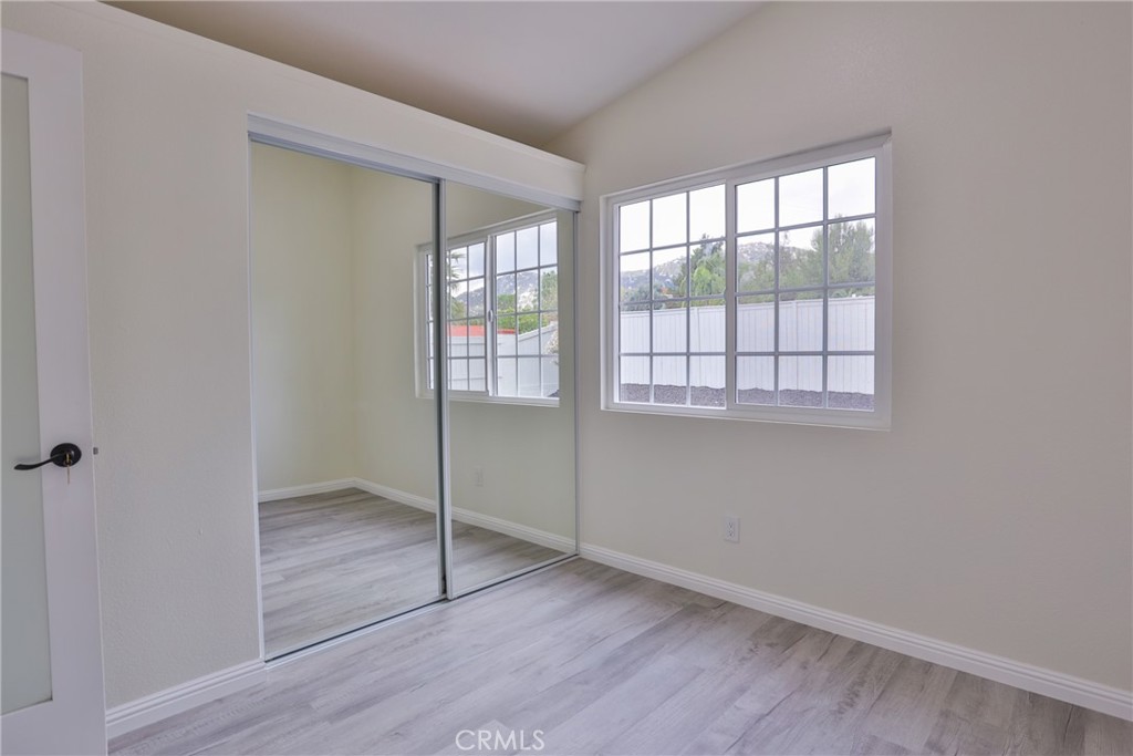 45800 Classic Way Temecula, CA 92592 - Photo 30 of 61 an empty room with wooden floor and windows