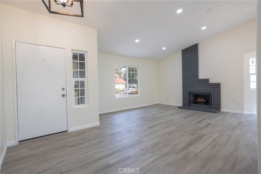 45800 Classic Way Temecula, CA 92592 - Photo 9 of 61 an empty room with windows and fireplace