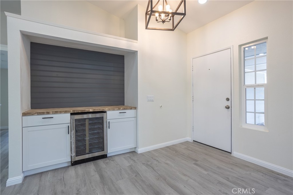 45800 Classic Way Temecula, CA 92592 - Photo 10 of 61 an empty room with wooden floor cabinet and windows