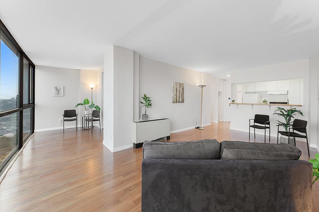 380 Mountain Road, Unit 907 Union City, NJ 07087 - Photo 13 of 25 a living room with furniture and a table with wooden floor