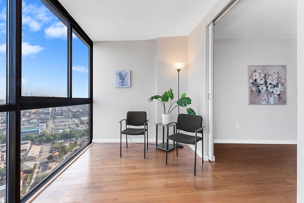 380 Mountain Road, Unit 907 Union City, NJ 07087 - Photo 5 of 25 a living room with furniture and a floor to ceiling window