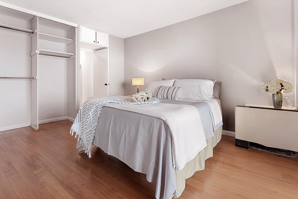 380 Mountain Road, Unit 907 Union City, NJ 07087 - Photo 7 of 25 a bed room with a bed and a night stand