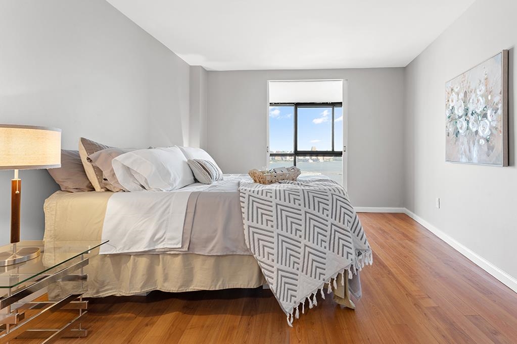 380 Mountain Road, Unit 907 Union City, NJ 07087 - Photo 8 of 25 a bedroom with a bed and wooden floor