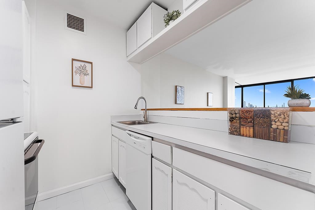 380 Mountain Road, Unit 907 Union City, NJ 07087 - Photo 10 of 25 a kitchen with sink and mirror