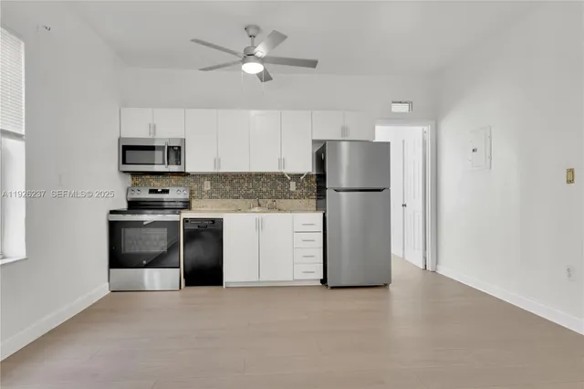 a kitchen with a refrigerator a stove top oven a sink and dishwasher