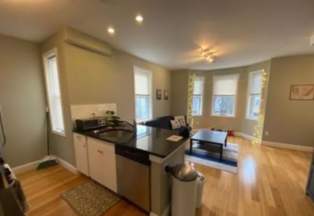 17 Ashley Street, Unit 2 Boston, MA 02130 - Photo 2 of 5 a kitchen with granite countertop a sink stove and cabinets