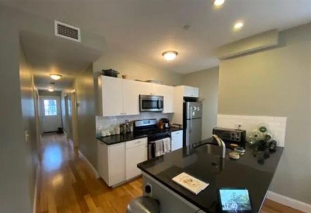 17 Ashley Street, Unit 2 Boston, MA 02130 - Photo 3 of 5 a living room with stainless steel appliances granite countertop furniture and a wooden floor