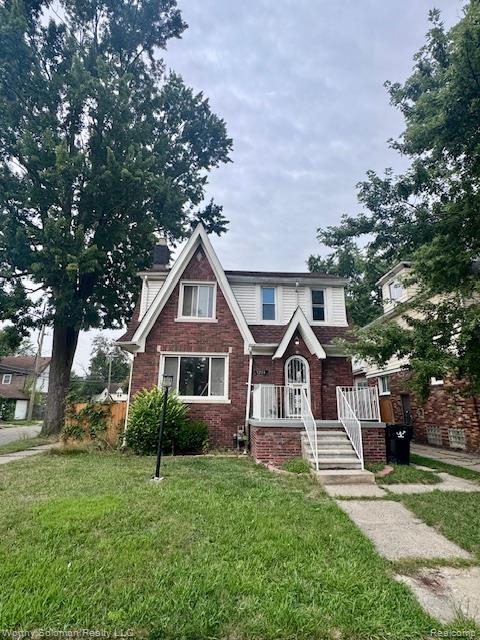 5203 Devonshire Road Detroit, MI 48224 - Photo 1 of 3 Brick and white siding exterior with a prominent gabled roofline and an arched entry