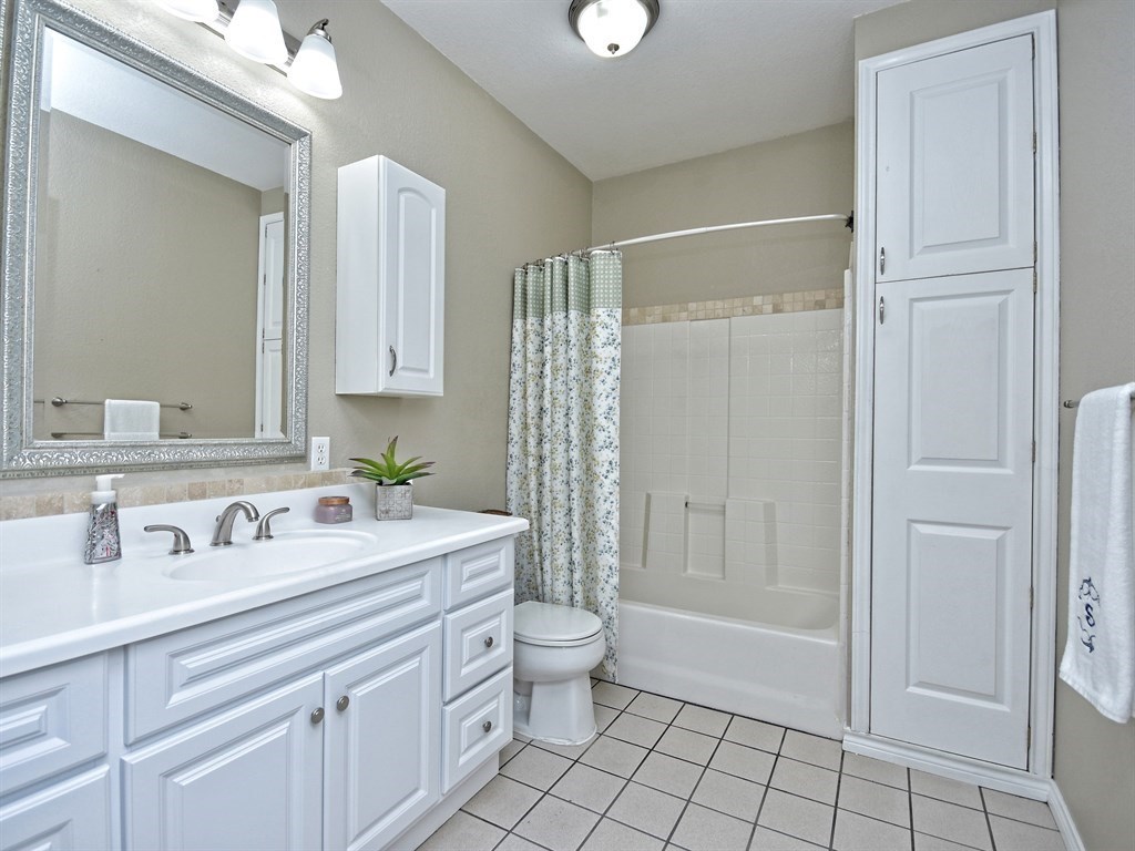 600 Grand Prairie Circle Dripping Springs, TX 78620 - Photo 13 of 25 a bathroom with a sink a toilet and shower