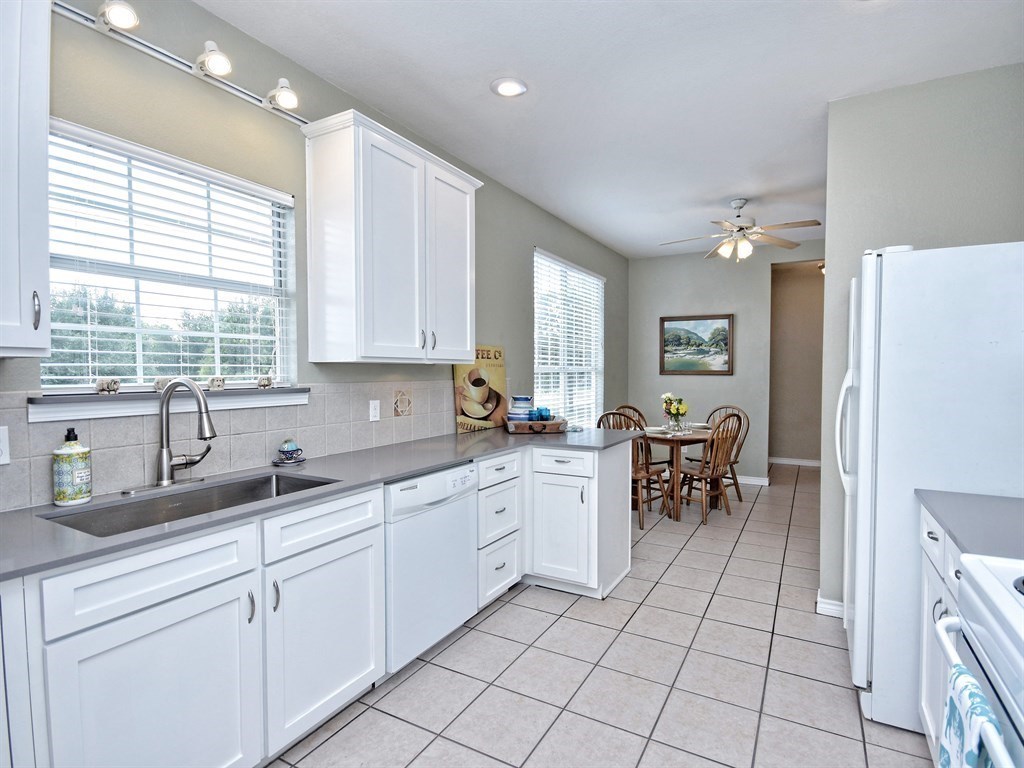 600 Grand Prairie Circle Dripping Springs, TX 78620 - Photo 7 of 25 a kitchen with sink cabinets and window