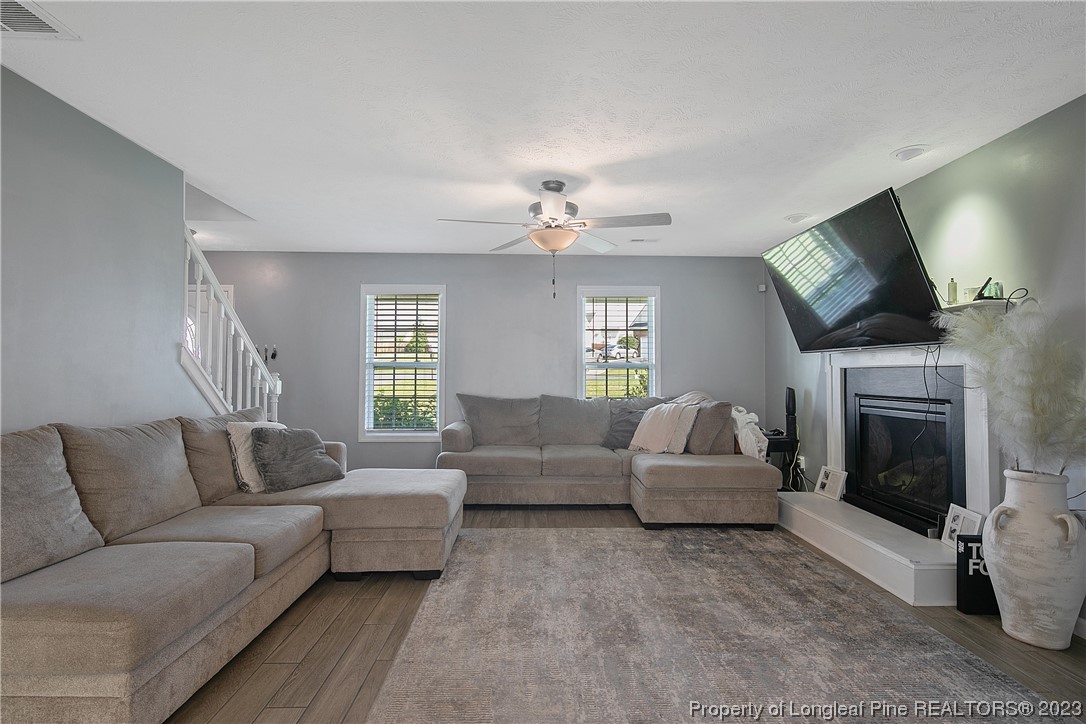 244 Rockingham Street Spring Lake, NC 28390 - Photo 11 of 34 a living room with furniture a fireplace and a flat screen tv