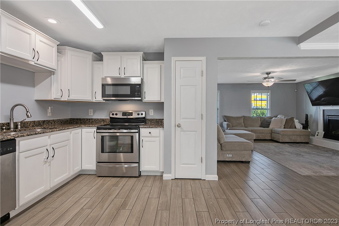 244 Rockingham Street Spring Lake, NC 28390 - Photo 17 of 34 a kitchen with a white cabinets and black stainless steel appliances