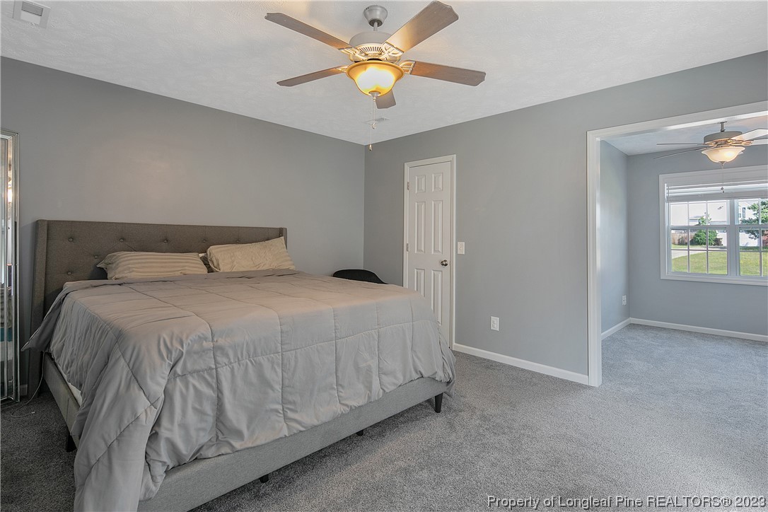 244 Rockingham Street Spring Lake, NC 28390 - Photo 19 of 34 a bedroom with a bed and a chandelier