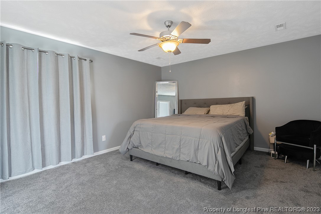 244 Rockingham Street Spring Lake, NC 28390 - Photo 20 of 34 a bedroom with a bed and a ceiling fan
