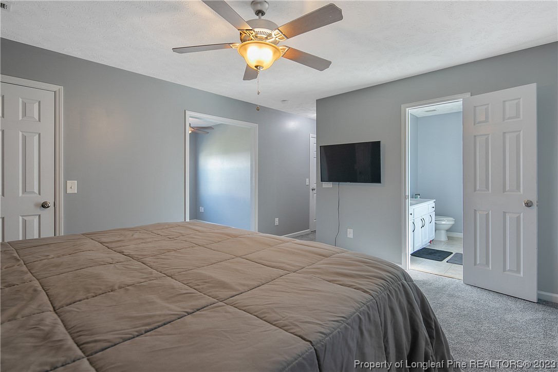 244 Rockingham Street Spring Lake, NC 28390 - Photo 21 of 34 a bedroom with a bed and a flat tv screen on dresser