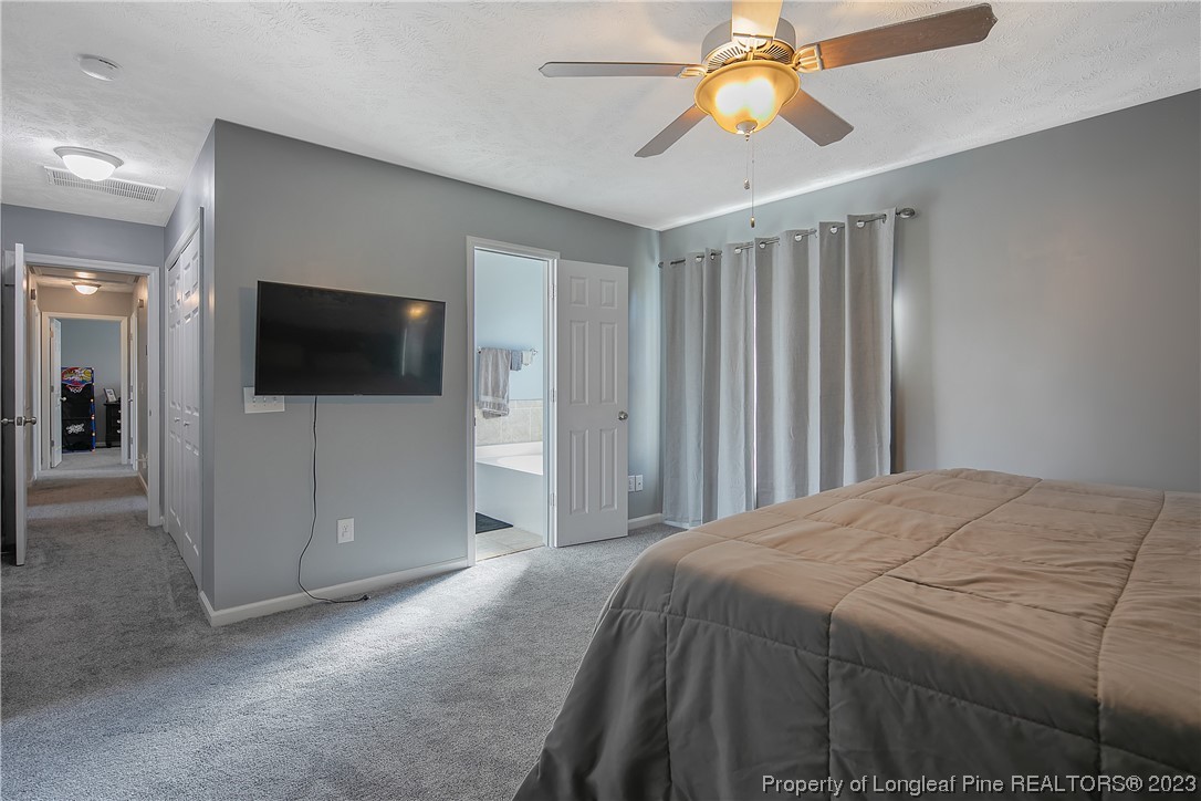 244 Rockingham Street Spring Lake, NC 28390 - Photo 22 of 34 a bedroom with a bed and a flat screen tv