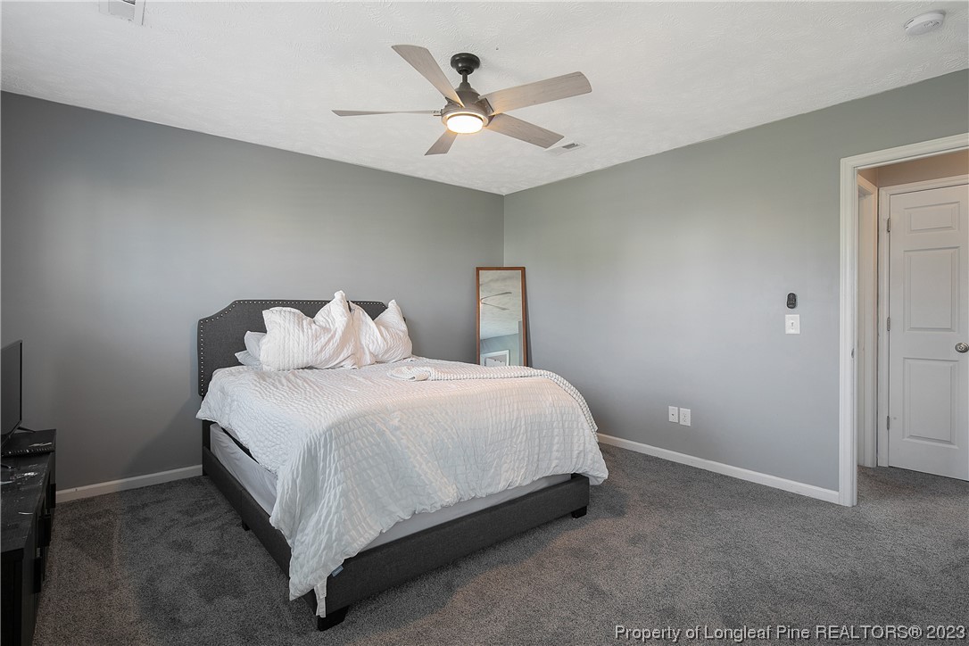 244 Rockingham Street Spring Lake, NC 28390 - Photo 28 of 34 a bedroom with a bed and ceiling fan