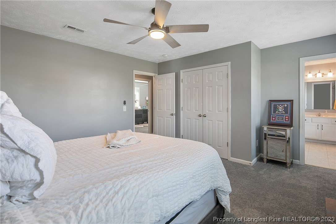 244 Rockingham Street Spring Lake, NC 28390 - Photo 29 of 34 a bedroom with a bed and a chandelier
