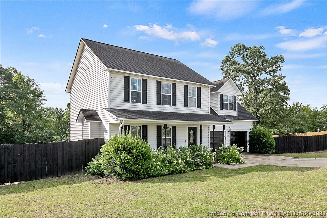 244 Rockingham Street Spring Lake, NC 28390 - Photo 3 of 34 a front view of a house with garden