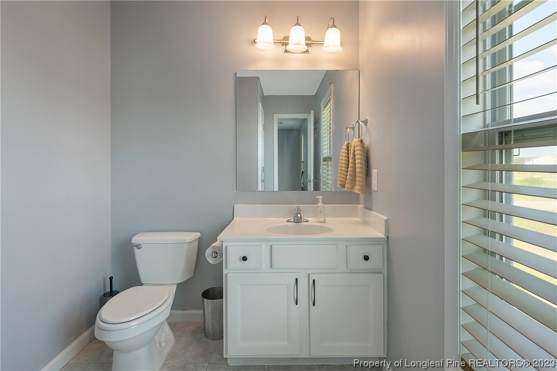 244 Rockingham Street Spring Lake, NC 28390 - Photo 31 of 34 a bathroom with a toilet sink and mirror