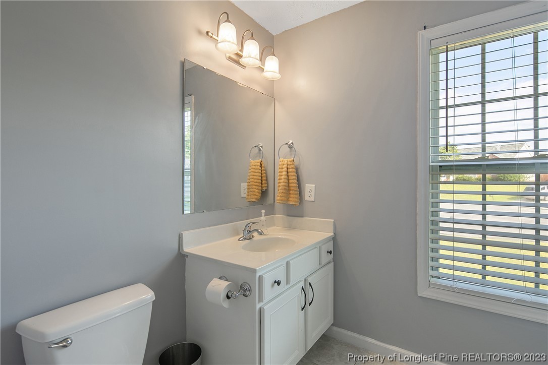 244 Rockingham Street Spring Lake, NC 28390 - Photo 32 of 34 a bathroom with a sink a toilet and a mirror