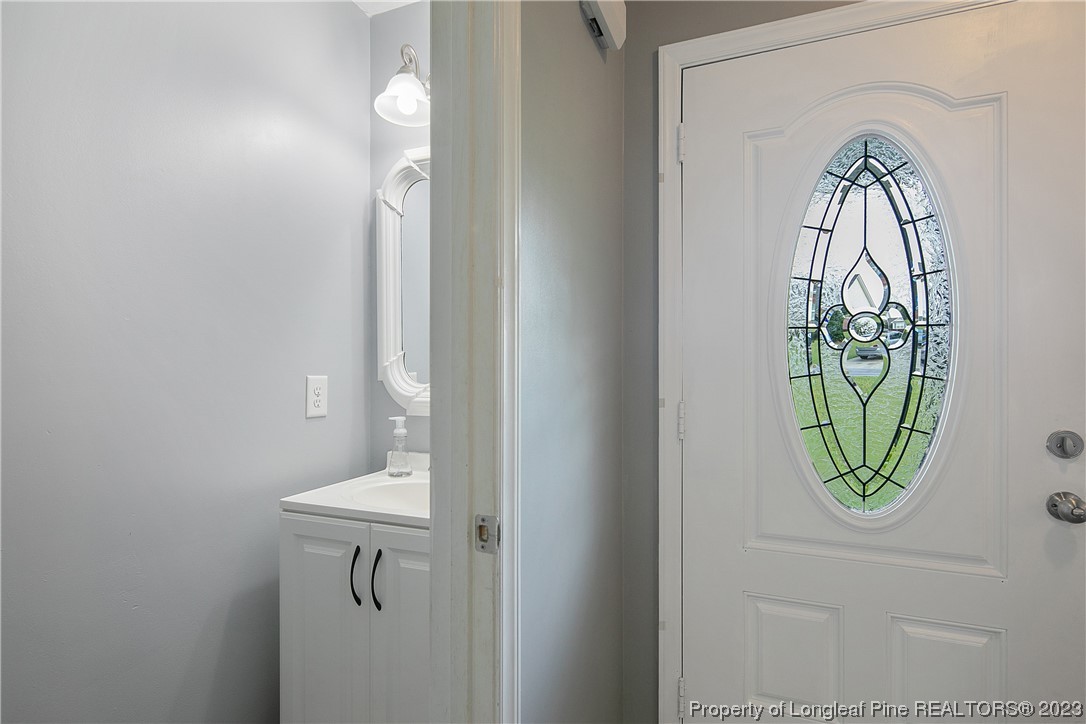 244 Rockingham Street Spring Lake, NC 28390 - Photo 6 of 34 a bathroom with a sink a mirror and a toilet