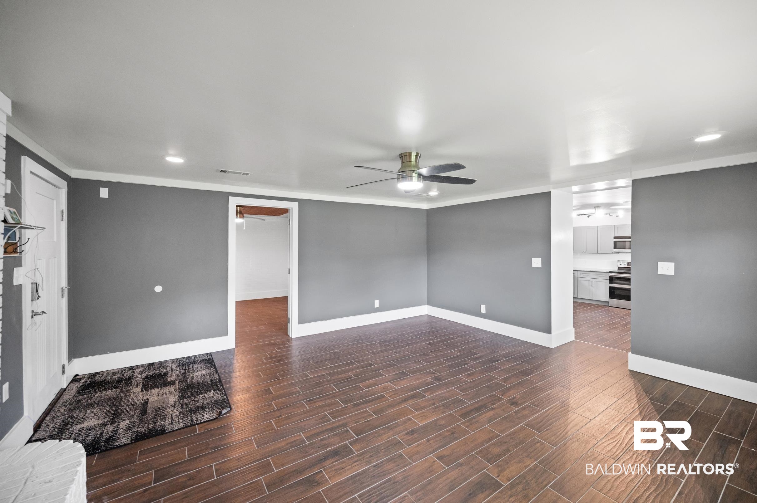 24663 Chestnut Street Elberta, AL 36530 - Photo 14 of 22 Spacious living area featuring wood-finish tile flooring, recessed lighting, and a ceiling fan