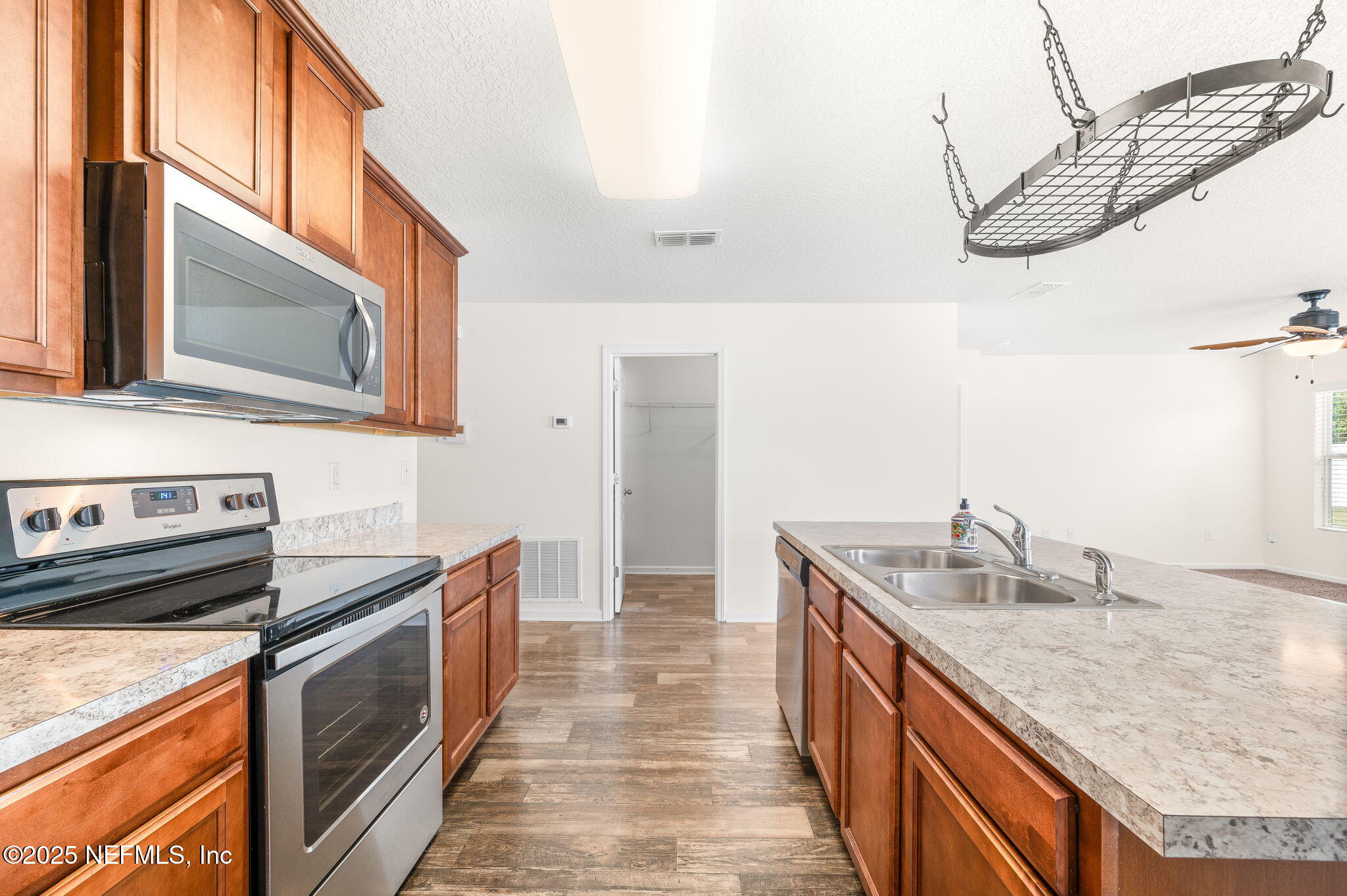 146 Blue Creek Way St. Augustine, FL 32086 - Photo 15 of 38 a kitchen with stainless steel appliances granite countertop a sink and stove top oven