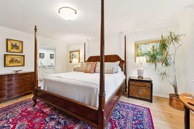 a bedroom with a bed and a potted plant